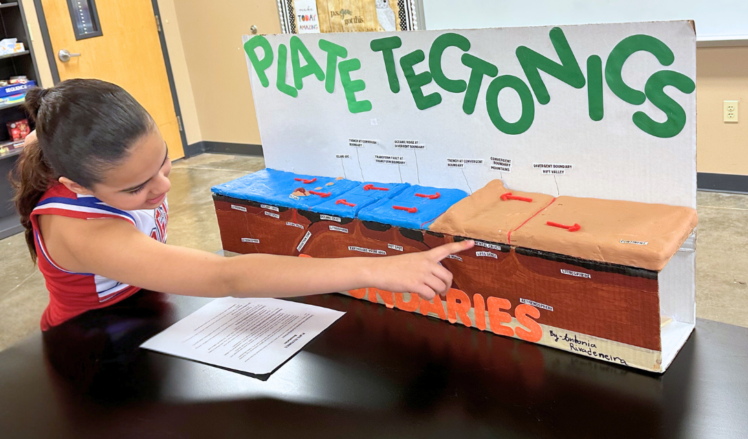 Girl showing off her science project