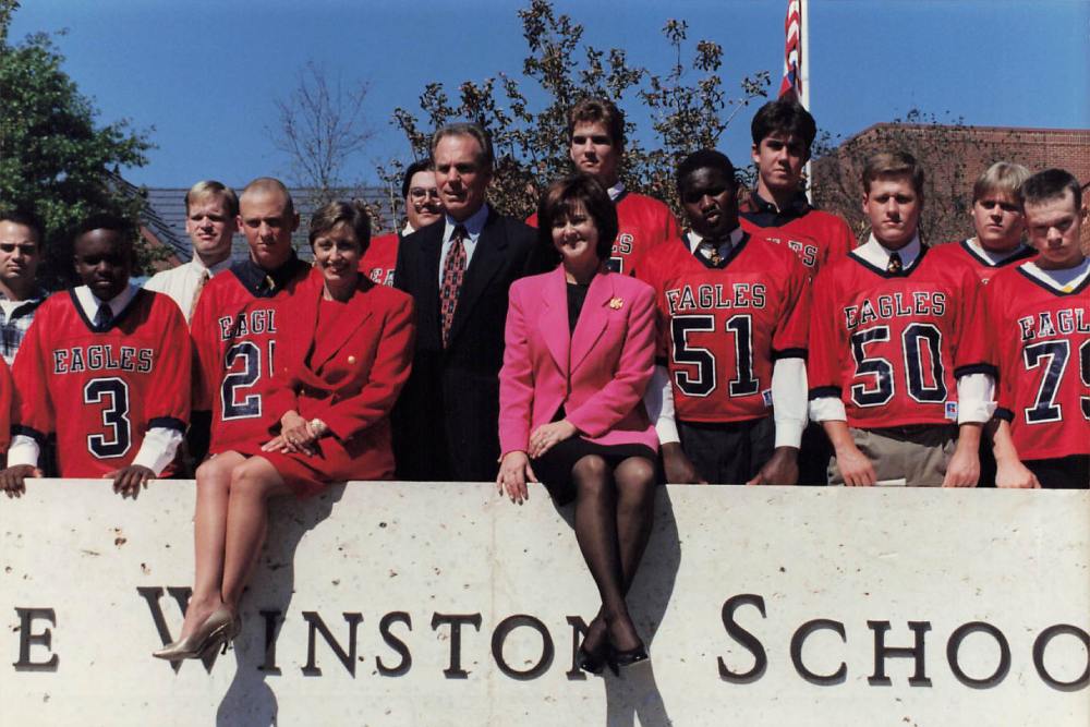 Picture of the head of school and football players at The Winston School in the 1990s.
