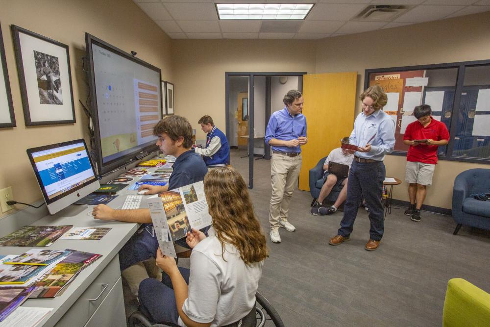 Students and teacher working on college admissions at The Winston School in Dallas, Texas.