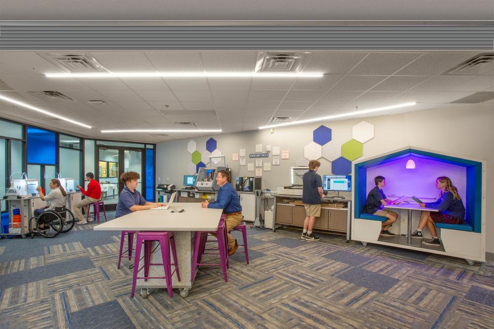 Picture of students and teachers interacting in the maker space at The Winston School in Dallas, Texas.